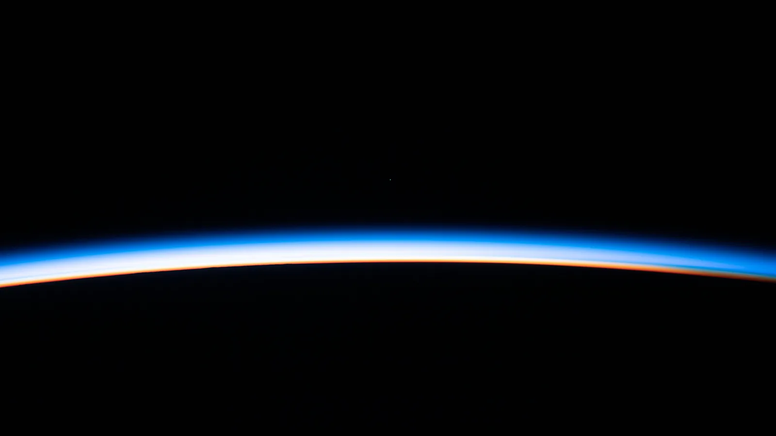 First light of an orbital sunrise over Earth's horizon, photographed from the International Space Station (NASA)